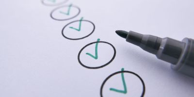 a marker near checked circles on white paper